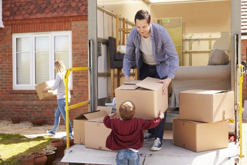 Moving boxes and furniture during a Belgium removals service in a city setting