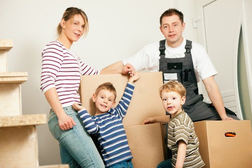 Professional movers handling furniture in a Belgian city