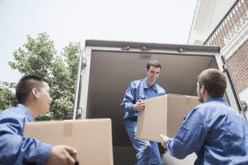 Business movers handling office furniture in a Belgian city