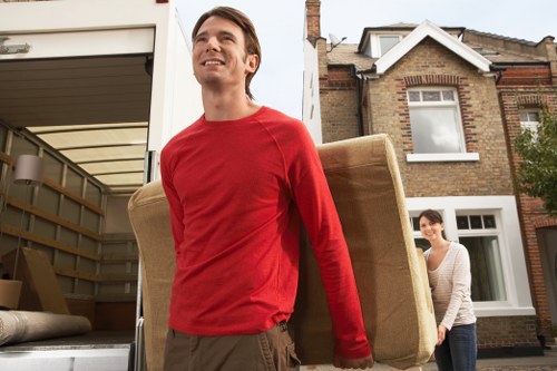 Moving team handling furniture during house removals in Belgium